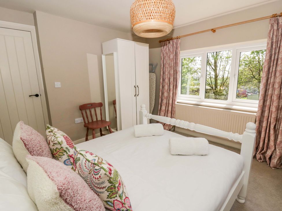 A bedroom with a bed and wardrobe at La Bastille in Maenclochog