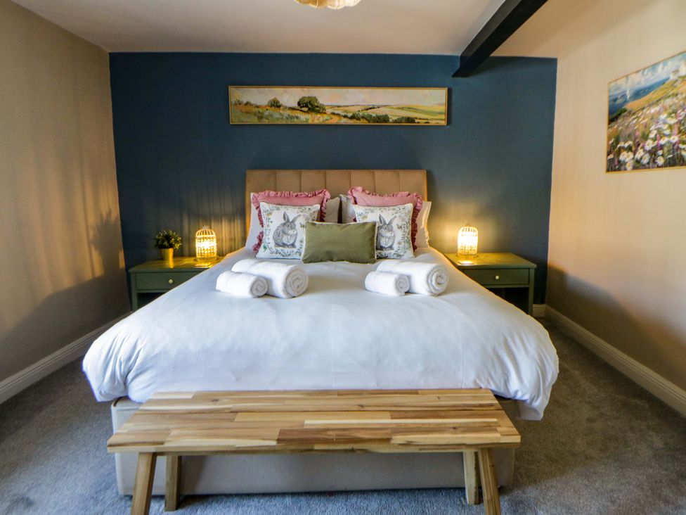 A bedroom with a bed and bedside table at La Bastille in Maenclochog