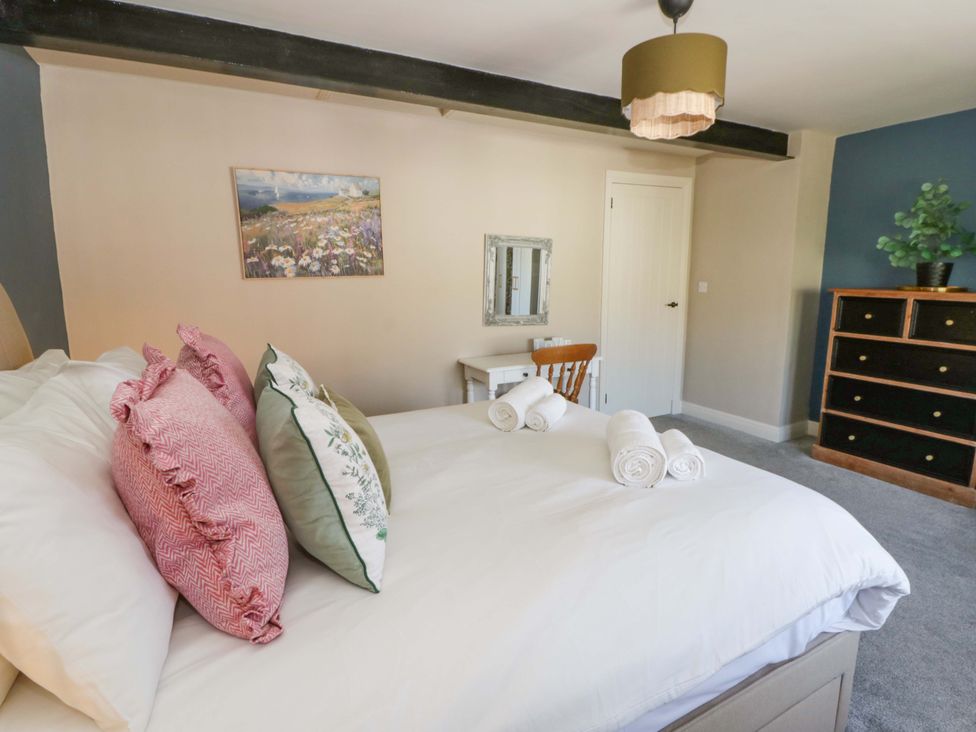 A bedroom with a bed and pillows at La Bastille in Maenclochog