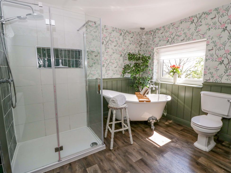 A bathroom with a shower and bathtub at La Bastille in Maenclochog
