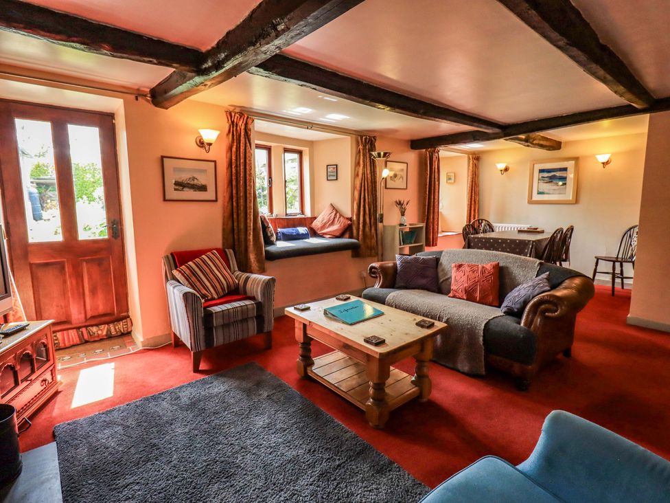 A living room with a sofa and coffee table at Tethera Cottage, Bampton, Cumbria