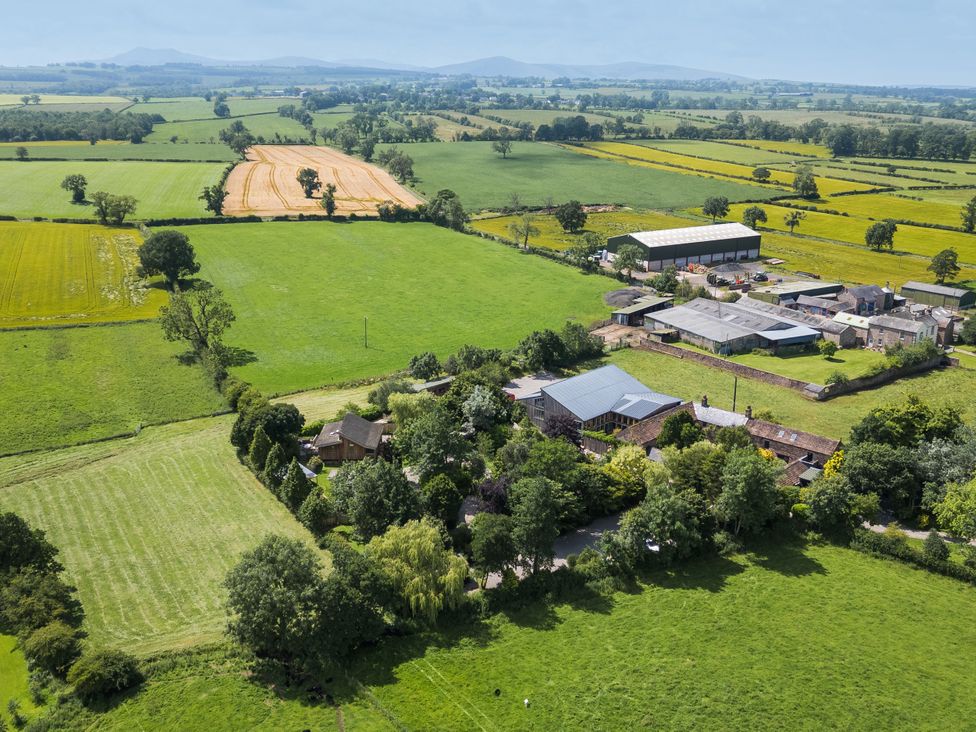 An aerial view of fields and buildings at Cedrus Lodge in Skelton near Penrith