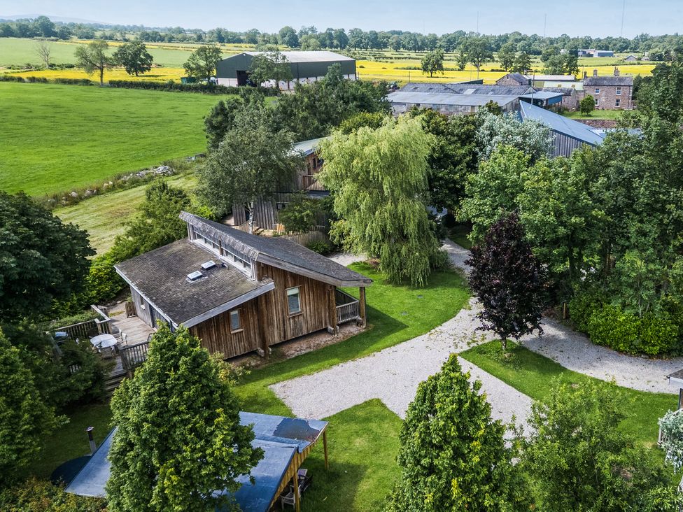 An outdoor view of houses and farm buildings at Cedrus Lodge in Skelton near Penrith
