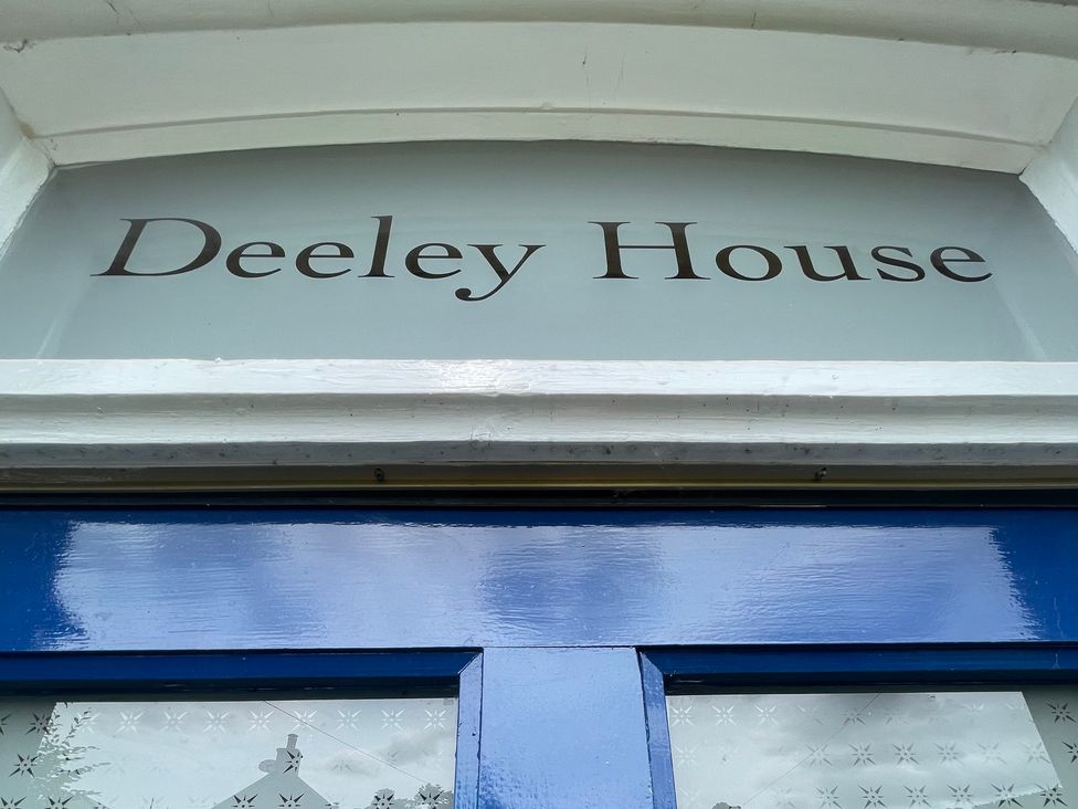 A door with a glass panel displaying Deeley House at Deeley House Darley Dale