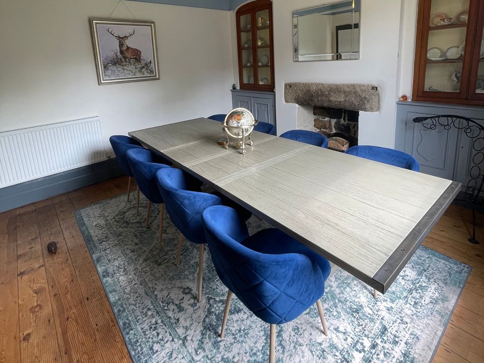 A dining room with a large table and chairs at Deeley House in Darley Dale
