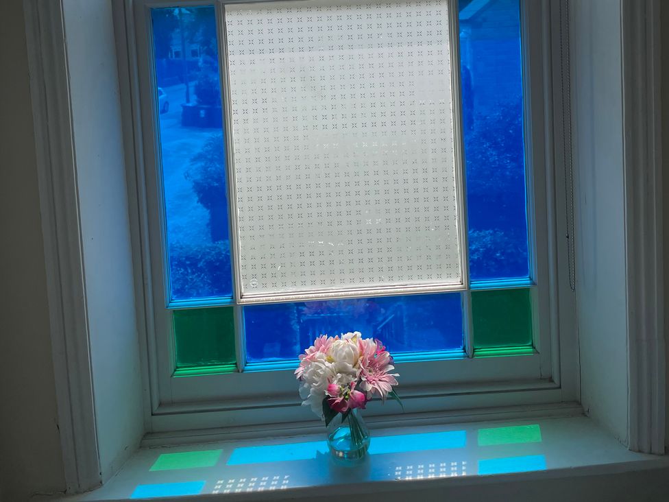 A window with a flower vase on a sill at Deeley House Darley Dale