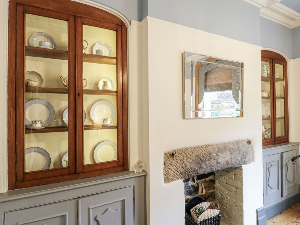 A dining room with a crockery display cabinet at Deeley House Darley Dale