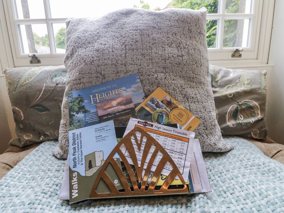 A magazine holder with brochures and timetables in a sitting room at Deeley House in Darley Dale