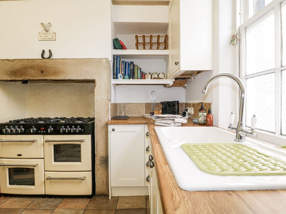 A kitchen with a stove and sink at Deeley House in Darley Dale
