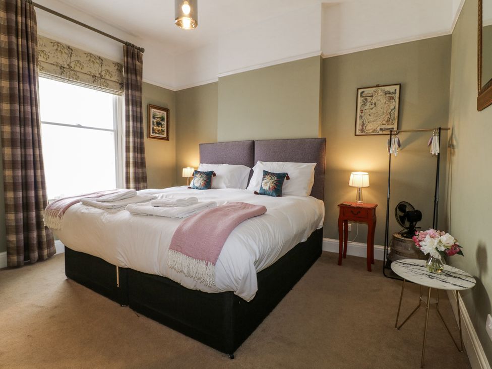 A bedroom with a bed and bedside table at Deeley House in Darley Dale
