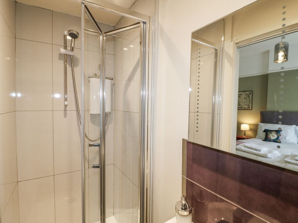 A shower with glass door in the bathroom at Deeley House Darley Dale