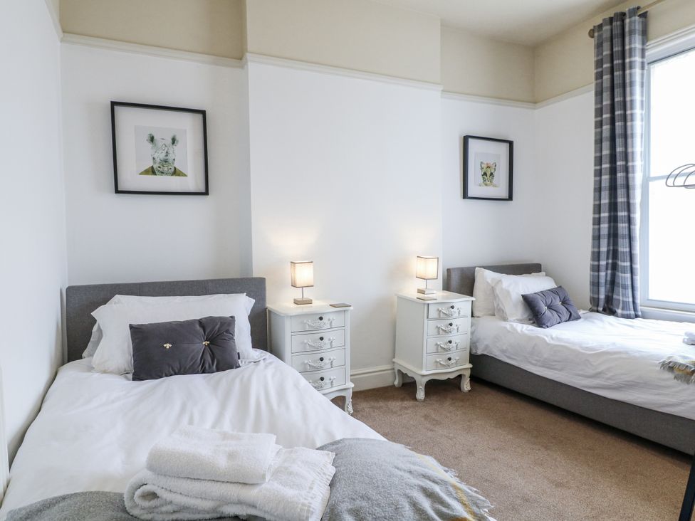 A bedroom with two beds and nightstands at Deeley House in Darley Dale