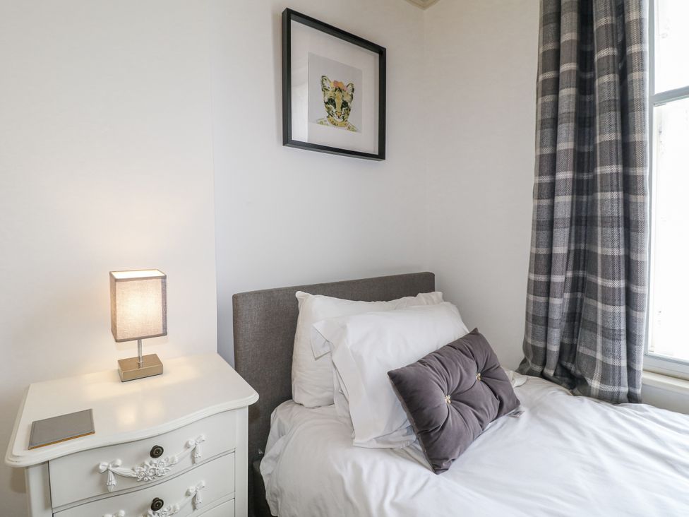 A bedroom with a bed and lamp at Deeley House in Darley Dale