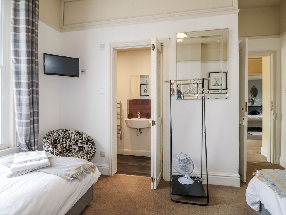 A bedroom with a bed and a TV at Deeley House in Darley Dale