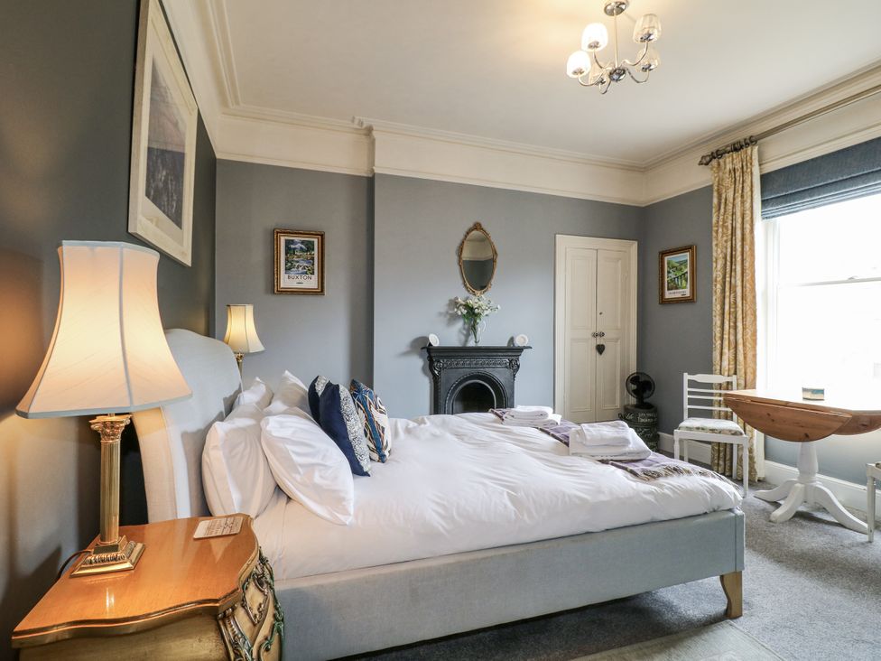A bedroom with a bed and side table at Deeley House in Darley Dale