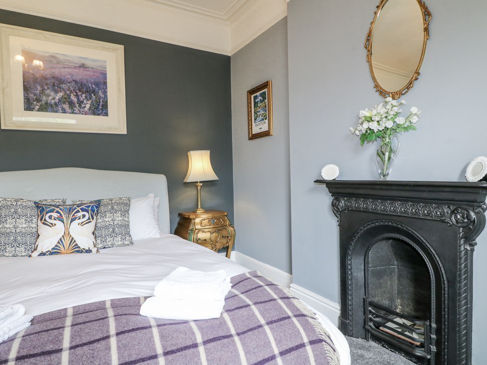 A bedroom with a bed and lamp at Deeley House in Darley Dale