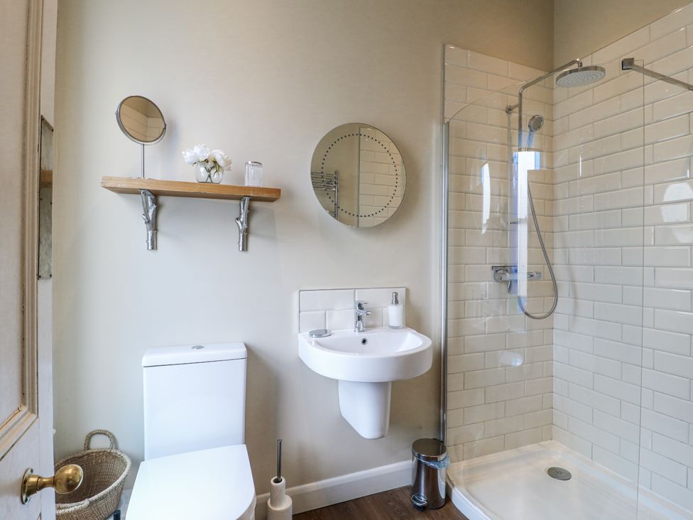 A bathroom with a shower and sink at Deeley House in Darley Dale
