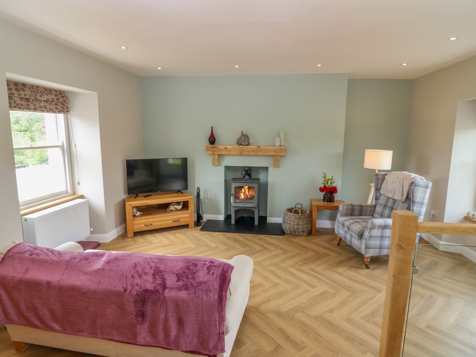 A living room with a sofa and television at Ashlea in Oxton near Lauder