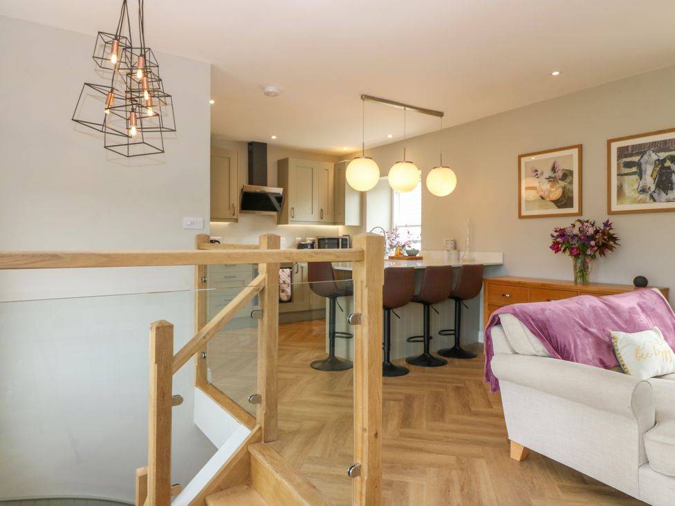 A living room with bar stools and a kitchen in Ashlea Oxton near Lauder