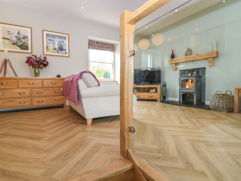 A living room with a fireplace and television at Ashlea in Oxton near Lauder