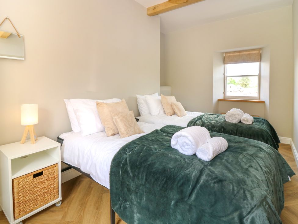 A bedroom with two beds and a lamp at Ashlea in Oxton near Lauder