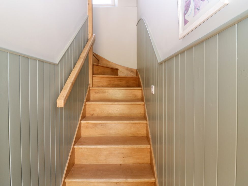 A staircase with wooden stairs and a handrail at Ashlea in Oxton near Lauder