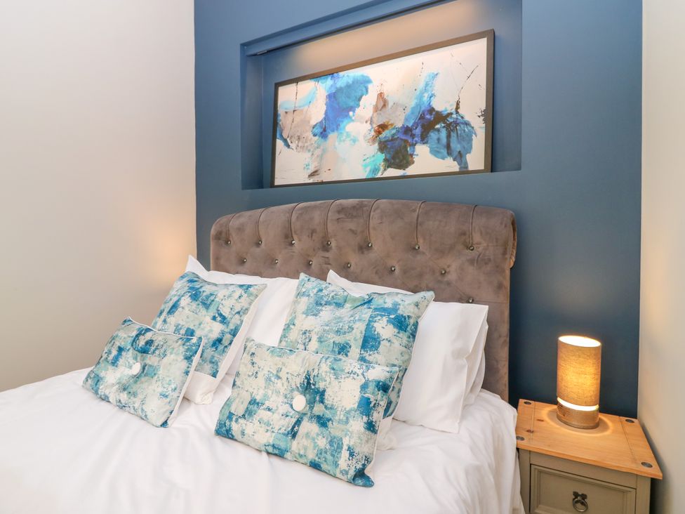 A bedroom with a bed and decorative pillows at Ashlea in Oxton near Lauder