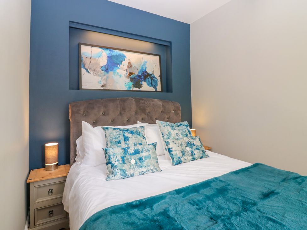 A bedroom with a bed and artwork on the wall at Ashlea in Oxton near Lauder