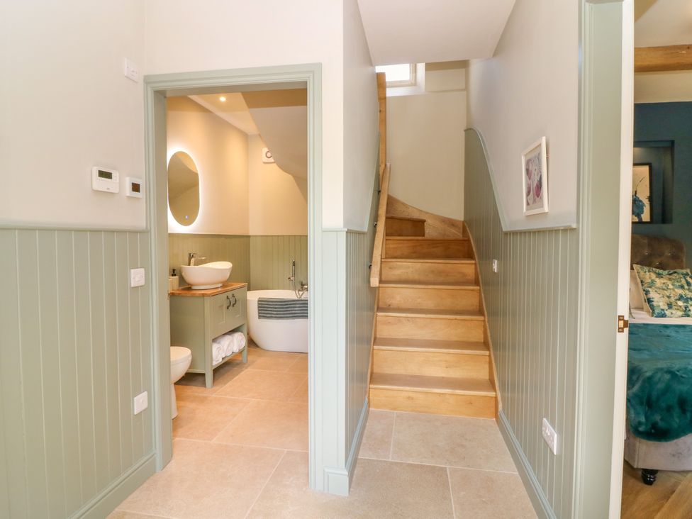 A hallway with stairs and a bathroom area at Ashlea in Oxton near Lauder