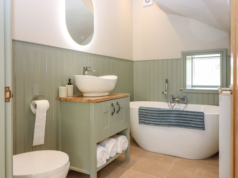 A bathroom with a sink and bathtub at Ashlea in Oxton near Lauder