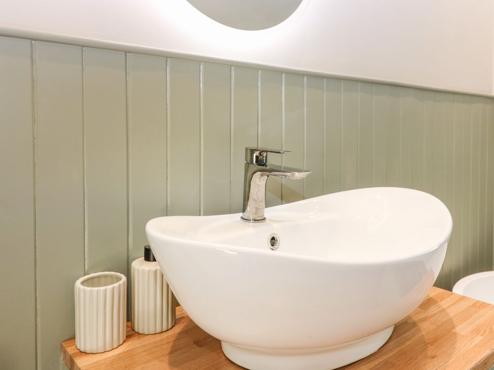 A bathroom with a sink and wooden countertop at Ashlea in Oxton near Lauder