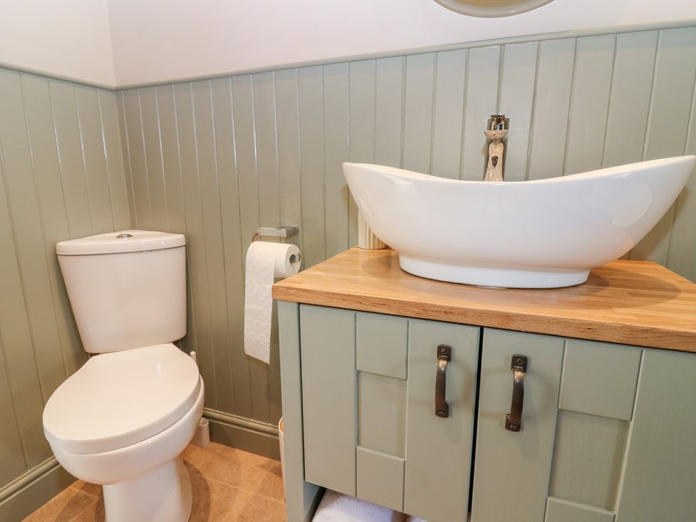 A bathroom with a toilet and wash basin at Ashlea in Oxton near Lauder
