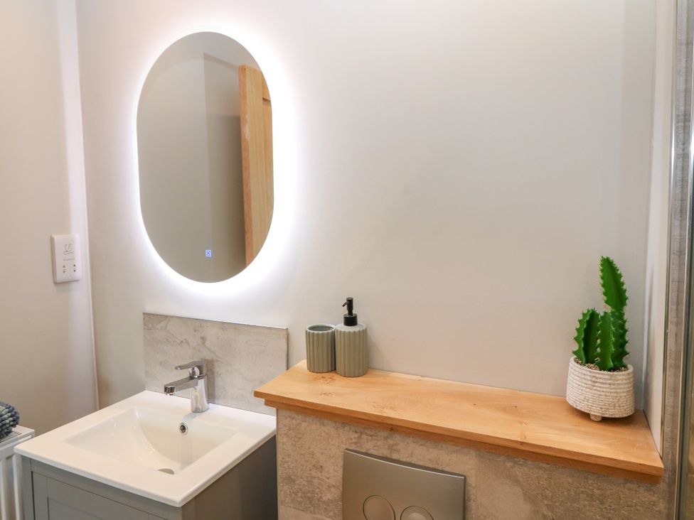 A bathroom with a sink and mirror at Ashlea Oxton near Lauder