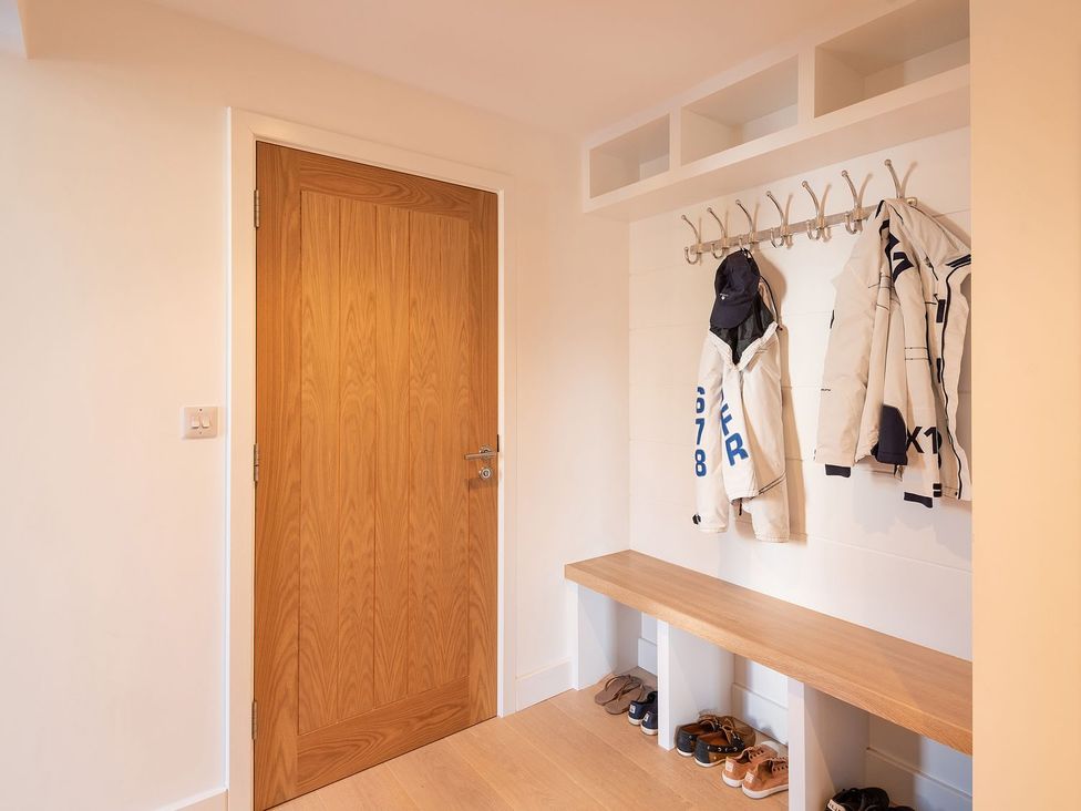 A hallway with a coat rack and shoes at Pentire in St Minver