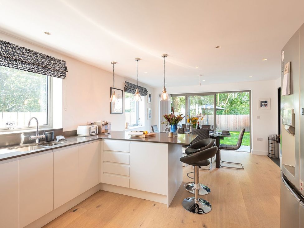 A kitchen with a countertop and dining area at Pentire in St Minver