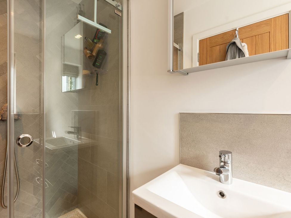 A bathroom with a shower and sink at Pentire in St Minver
