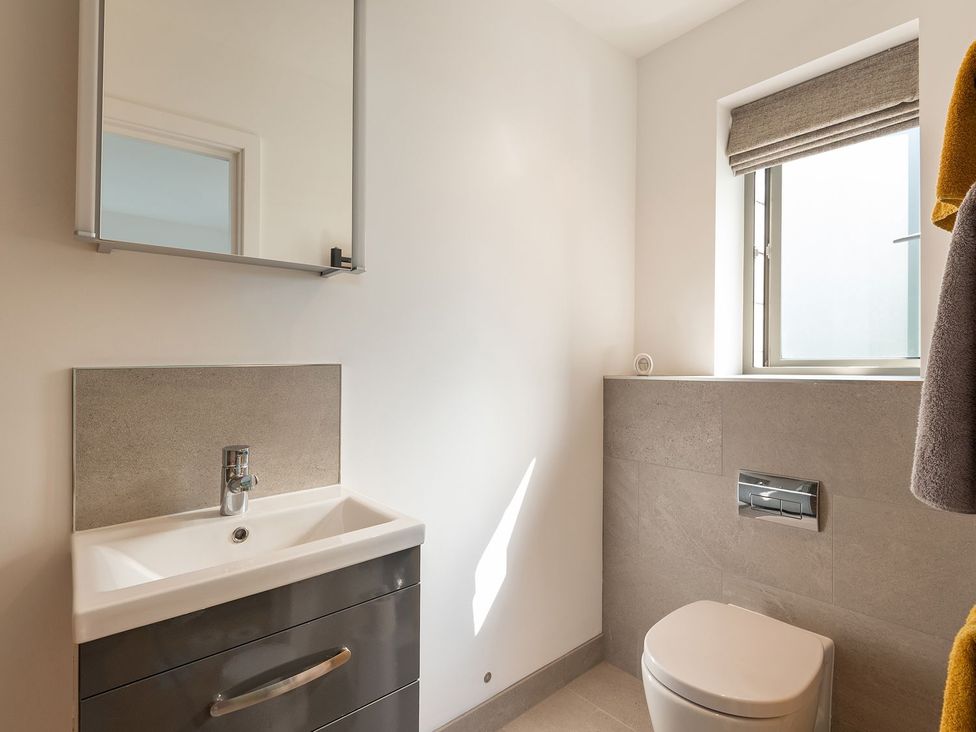 A bathroom with sink and mirror at Pentire in St Minver