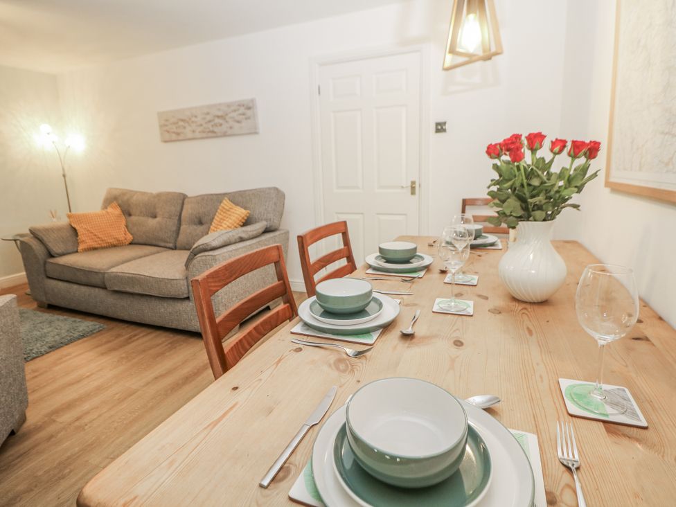 A dining room with a table set for a meal at 6 Fidlers Close Bamford