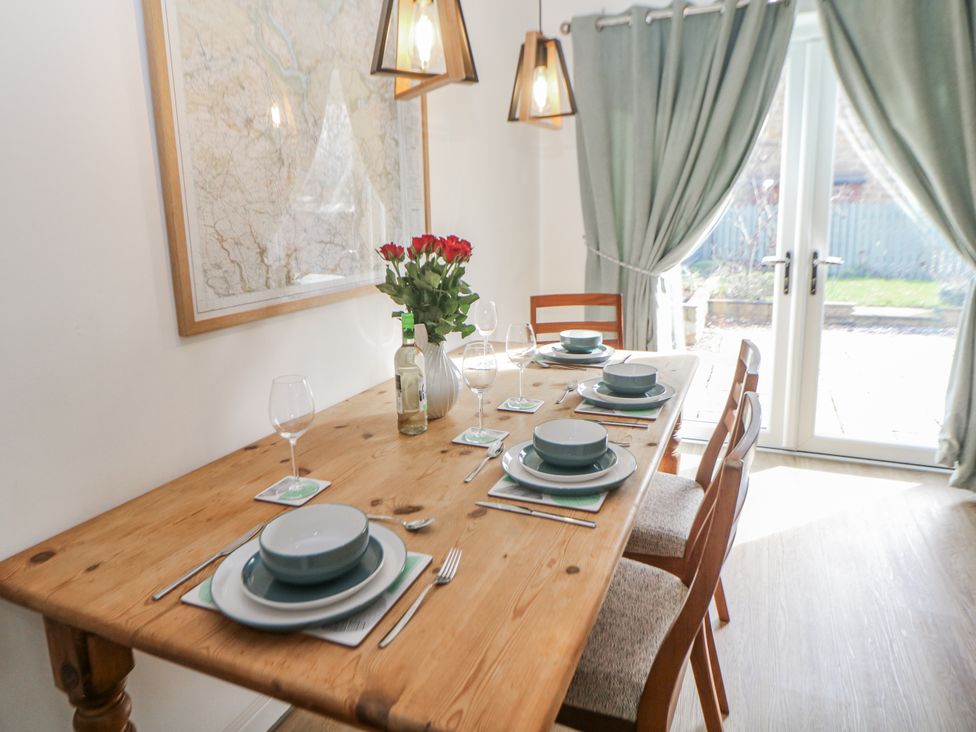 A dining room with a table set for a meal at 6 Fidlers Close, Bamford