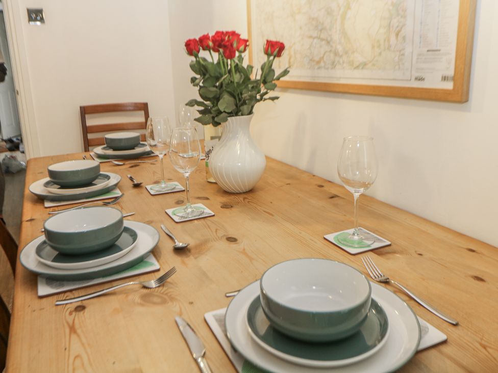 A dining room with a table set for dinner at 6 Fidlers Close Bamford