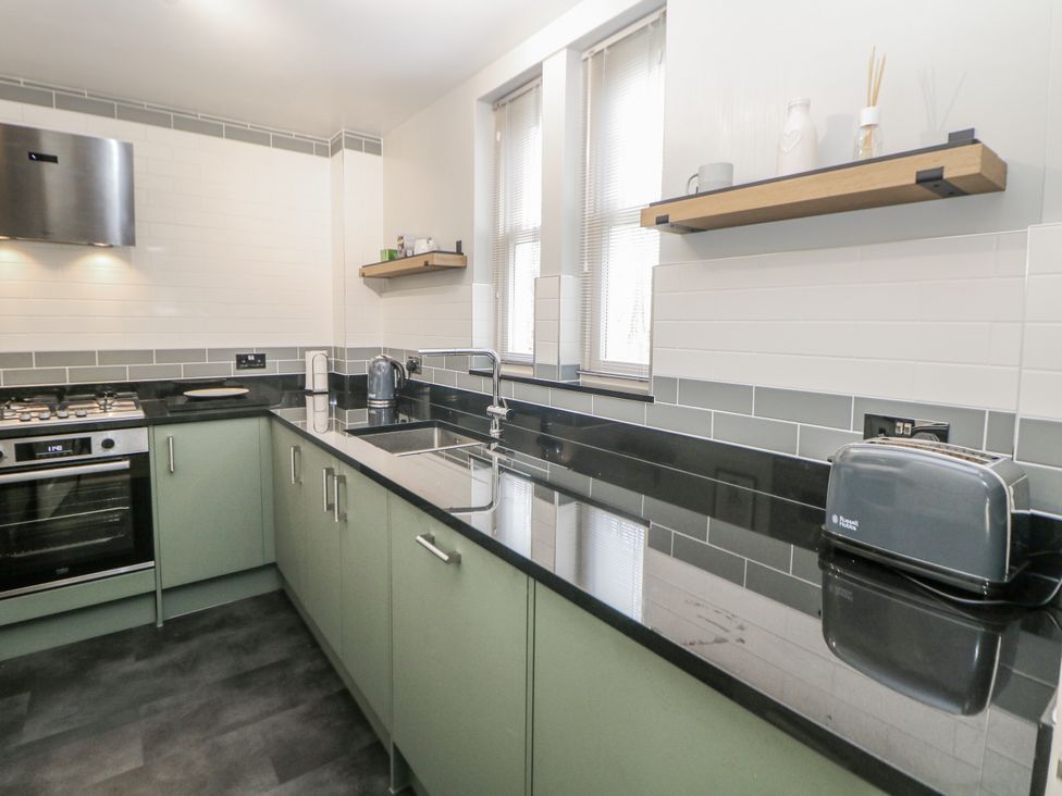 A kitchen with countertop, oven, sink, and toaster at 6 Fidlers Close Bamford