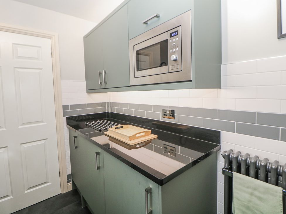 A kitchen with a microwave and countertop at 6 Fidlers Close Bamford