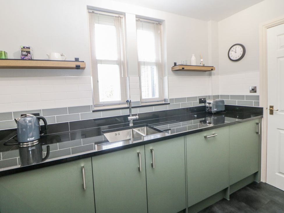 A kitchen with a sink and appliances at 6 Fidlers Close in Bamford