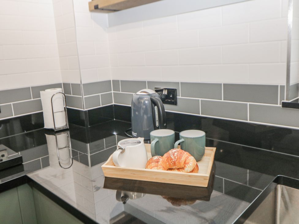 A kitchen with kettle, cups and croissants on a tray at 6 Fidlers Close in Bamford