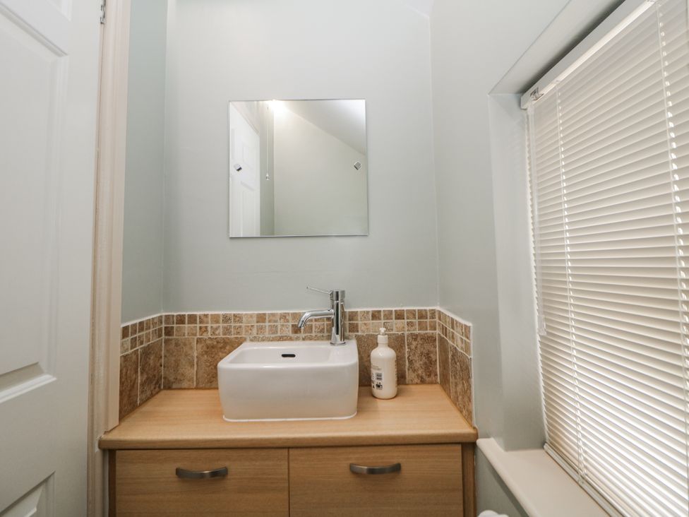 A bathroom with a sink and mirror at 6 Fidlers Close Bamford