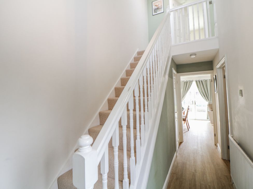 A hallway with staircase and doors at 6 Fidlers Close in Bamford