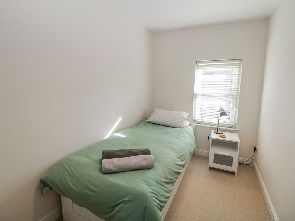 A bedroom with a bed and a side table at 6 Fidlers Close Bamford