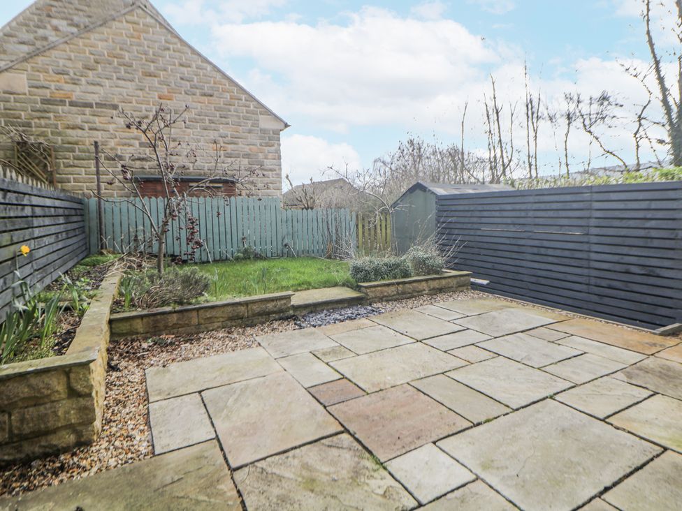 A garden with patio and grass area at 6 Fidlers Close Bamford