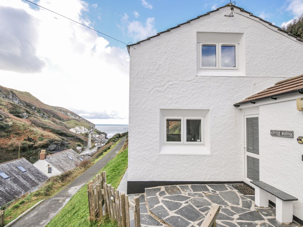 An exterior view of a house with a path and sea at Little Ruffo in Trebarwith near Tintagel