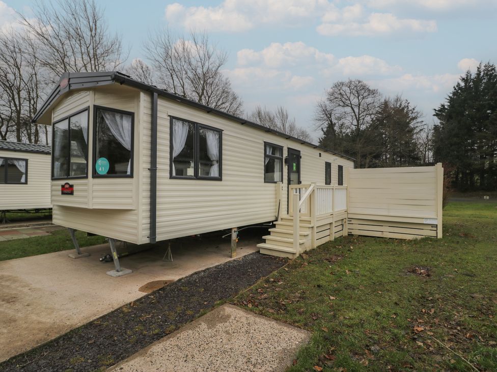 A static caravan with steps and decking at Woodlands Gold (WO 41) in Ruthin